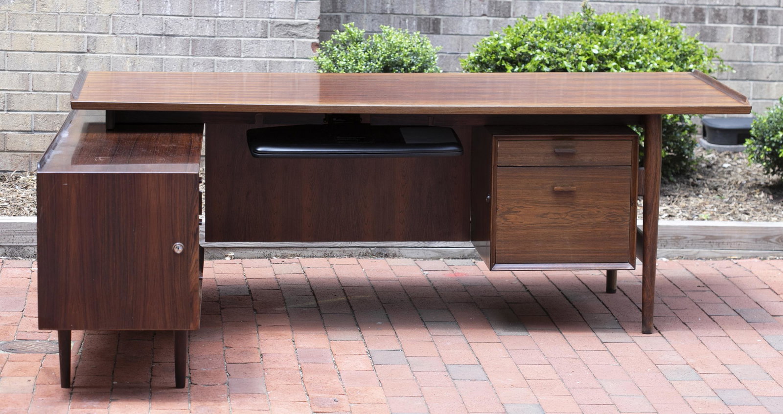 Arne Vodder for Sibast executive desk.: A Danish Modern Arne Vodder for Sibast executive desk. Rosewood flame veneer. Desk with two drawers. Sideboard with three drawers astride two sliding doors, with door on far end. 28 1/4" x 70 3/4" x 8
