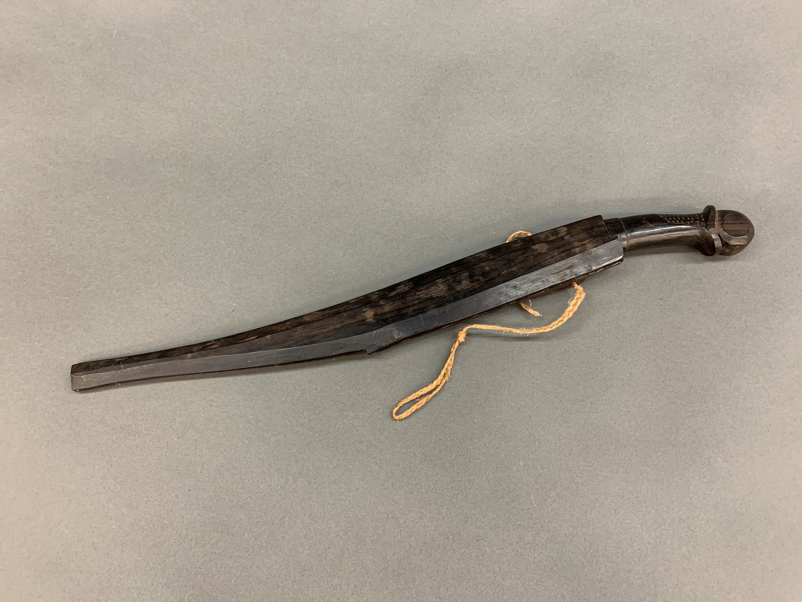 Philippine Talibon knife with sheath.: Philippine Talibon knife with sheath, 20th century. 14 1/4" single edged blade. Carved wood handle. Wood sheath. Dagger 19" and sheath 17" Condition: Sheath splitting.
