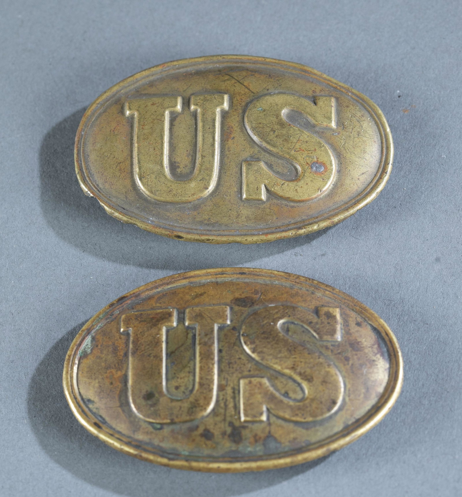 2 Civil War U.S. Union belt buckles.: A group of 2 Civil War U.S. Union belt buckles. Lead filled brass with three hook design. 3 3/8" x 2 1/8". Condition: Aging and patina present. Provenance: From the collection of Nicholas R. Burke, Wa