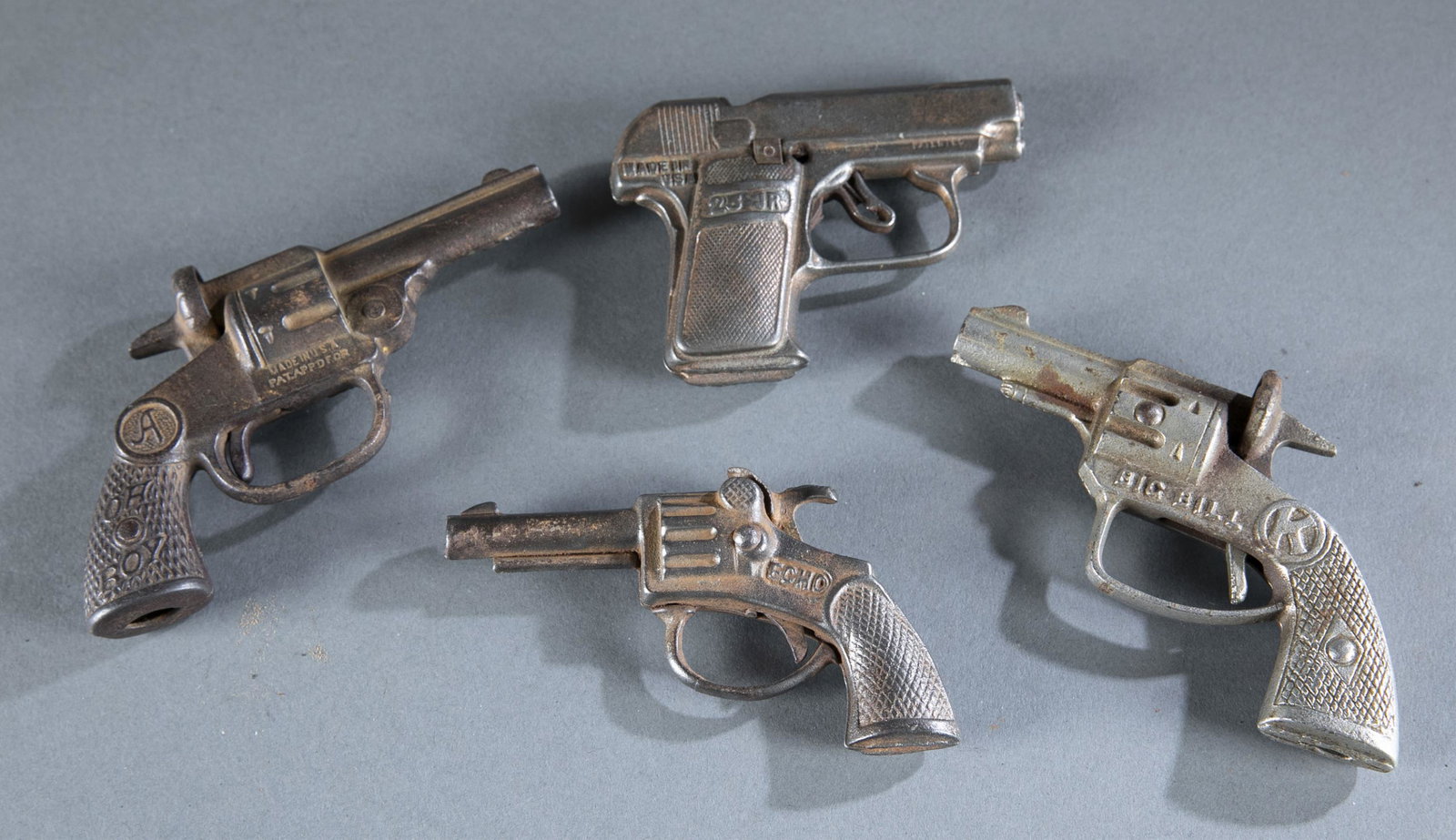 4 vintage cast iron cap guns.: A group of four vintage cast iron cap guns, circa 1930s. Andes "Oh Boy" single shot cap gun. Kilgore "Big Bill" single shot cap gun. Stevens 25 JR cap gun. Stevens "Echo" cap gun. Largest 5 1/2" x 3 1