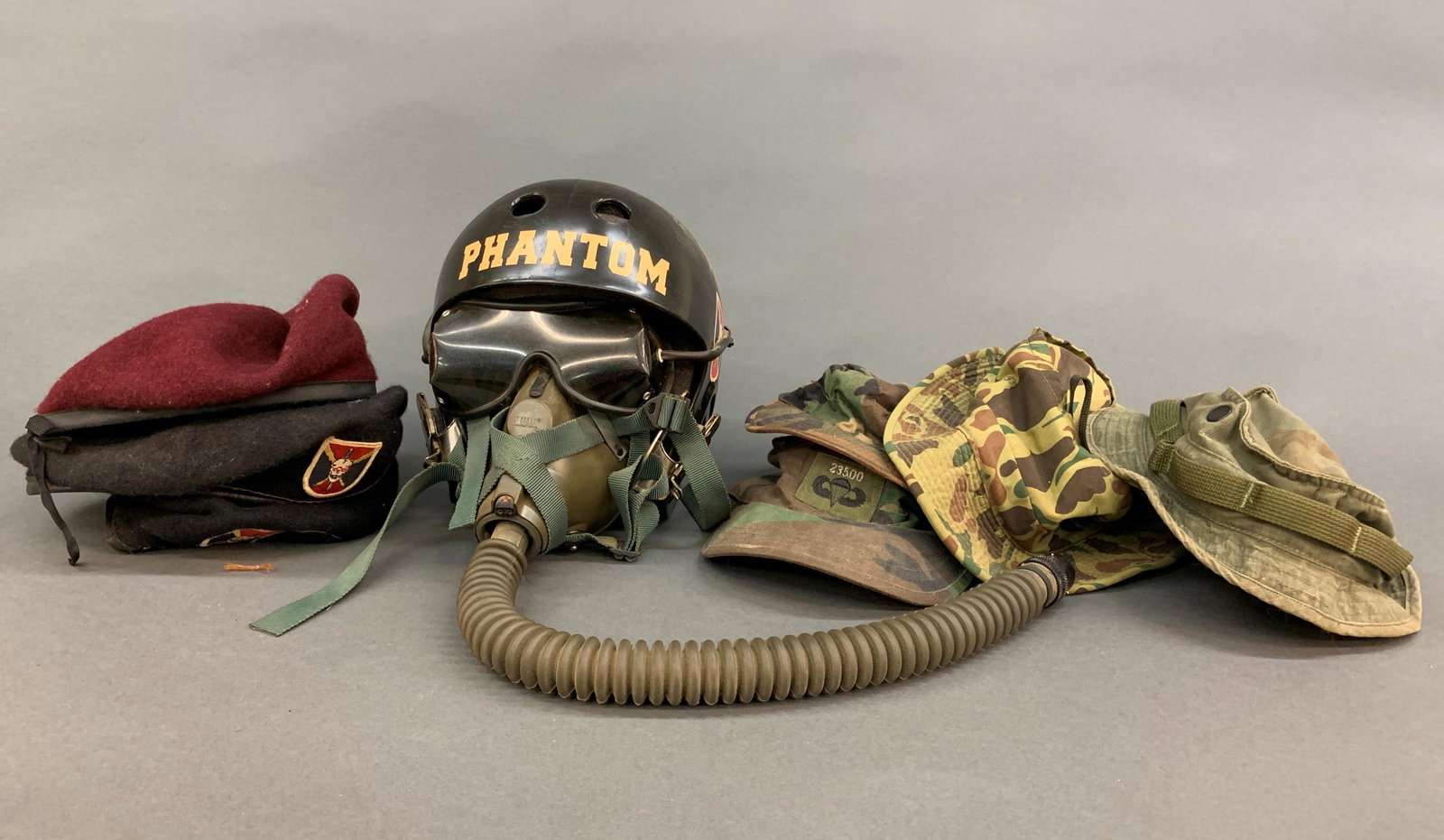Five U.S. Army hats and berets: Six U.S. Army hats, flight helmet and berets. Including two Phantom Airborne Brigade black berets with skull patches. Phantom Airborne Brigade flight helmet.