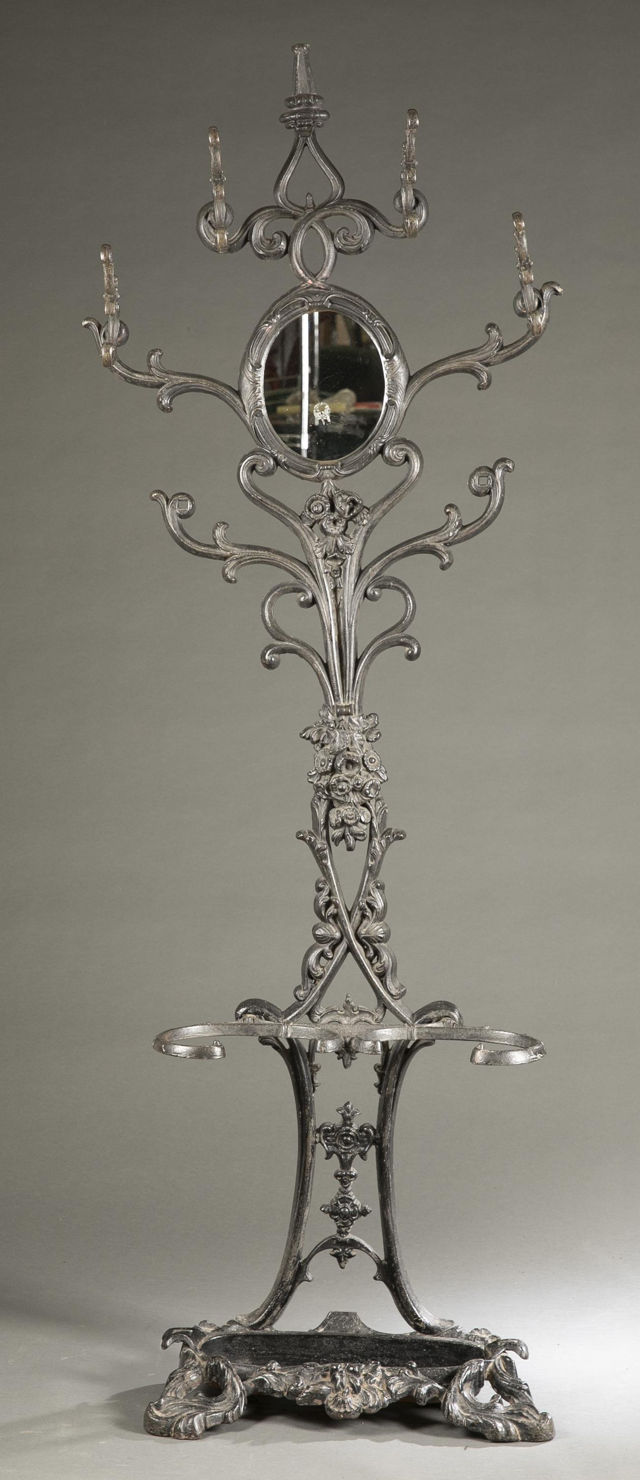 Cast iron hall tree.: A cast iron hall tree, 19th century. Removable umbrella pan. 74 1/2" x 26" x 12"Condition: Break on arm of umbrella pan.Provenance: From the Mike & Jean Clinton Family