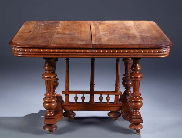 Henri II style walnut dining table: A Henri II style walnut dining table, having a rectangular top supported by spindled center supports on "H" stretcher joining four turned legs, resting on compressed ball feet, c.1860s, 30"h x 45"l x