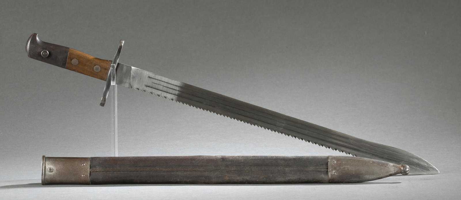 Swiss M1914 sawback bayonet and scabbard: A Swiss Model 1914 sawback sword bayonet with scabbard. Ricasso marked "Waffenfabrik/ Neuhausen." Early production leather scabbard. Serial 53554. Blade: 19 1/2" Overall: 24" Scabbard: 19 7/8"