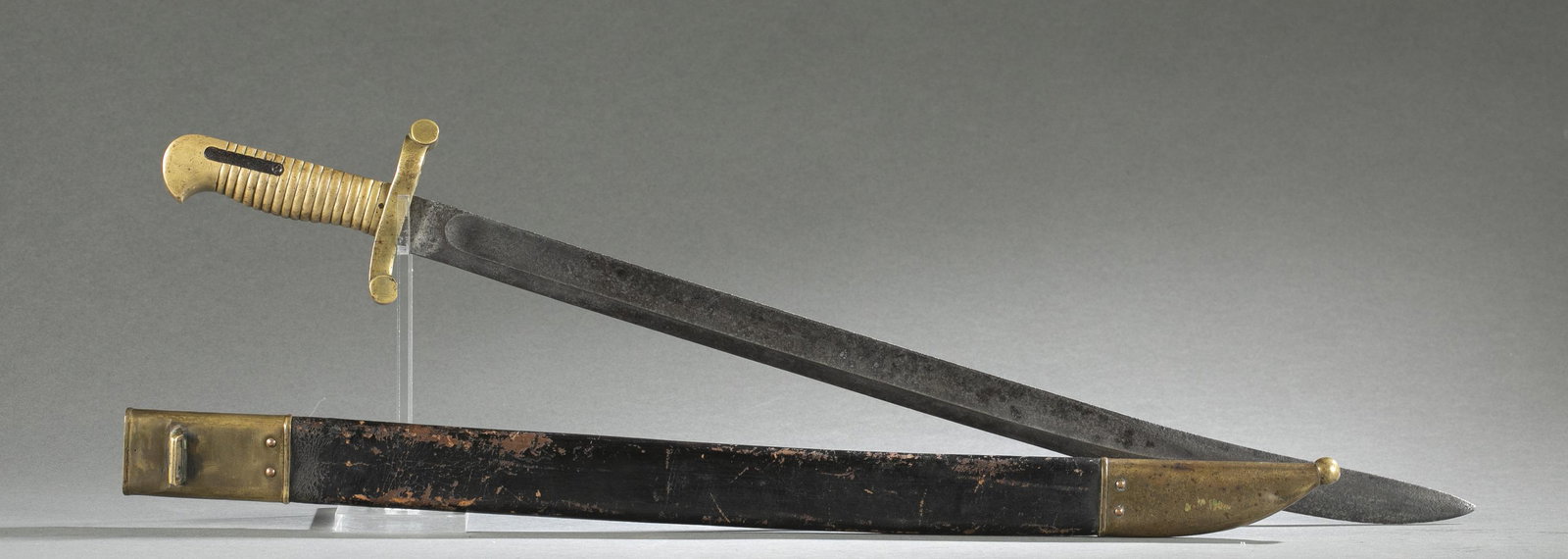 U.S. M1855 sword bayonet and scabbard.: A U.S. Model 1855 sword bayonet and scabbard. Marked with "H" inspector mark. Brass grip and cross guard. leather and brass scabbard. Blade: 21 3/4" Overall: 26 1/2"