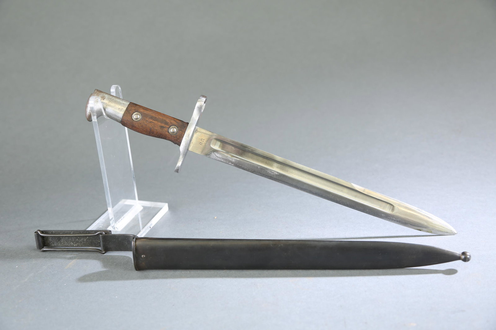 US M1892 Krag bayonet and scabbard: A US M1892 Krag bayonet and scabbard. Ricasso marked on the obverse "US" and reverse dated 1902. Steel crossguard, wood grips, and steel pommel. Metal sheath with metal frog. Blade:11 3/4" Overall: 16