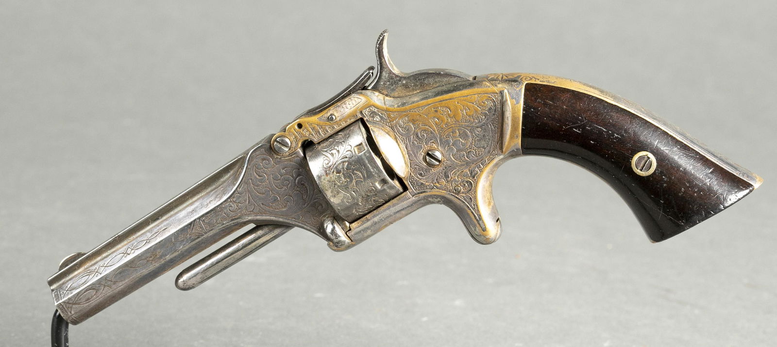 S&W No. 1 2nd Issue revolver, .22 Short.: [Antique Firearm] A Smith and Wesson engraved Model No. 1 2nd Issue revolver, .22 short. Silverplate on brass. 3 3/16" barrel with markings "SMITH AND WESSON SPRINGFIELD MASS." Early type backstrap. R