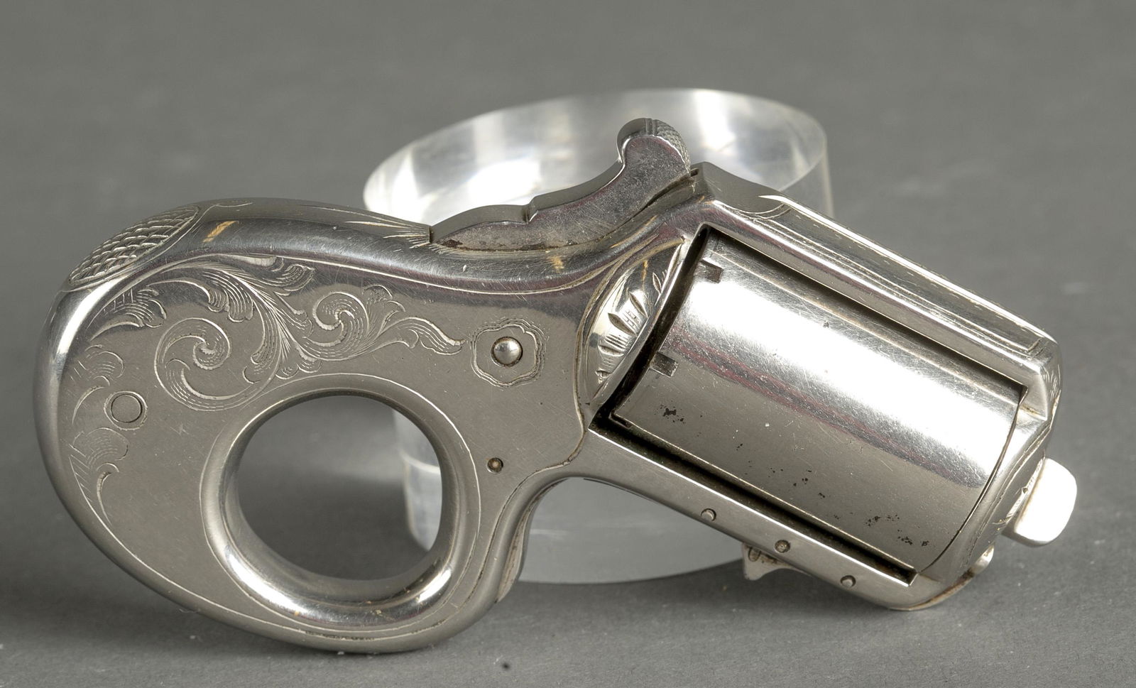 James Reid Kuckle-Duster revolver, .22 cal.: [Antique Firearm] A James Reid Kuckle-Duster revolver, .22 cal. Silverplate finish on brass frame. Scarce stamp below cylinder "MY FRIEND." Broad scroll engraved. Serial stamped on bottom 4660 and mat