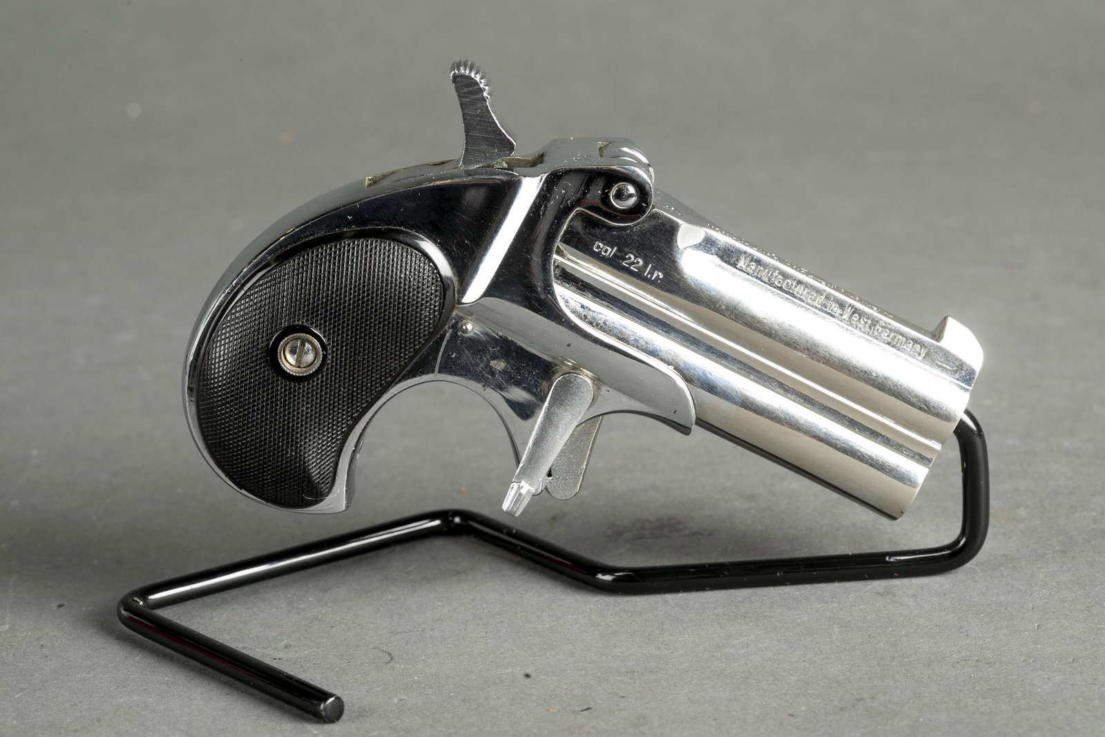 American Weapons Frontier Model Derringer, .22LR: [Modern Firearm] An American Weapons Corporation Frontier Model Derringer pistol, .22LR. Nickel finish. 3" barrel. Manufactured in West Germany. Checkered "HH" grips. Serial 74**.Condition: Very good 