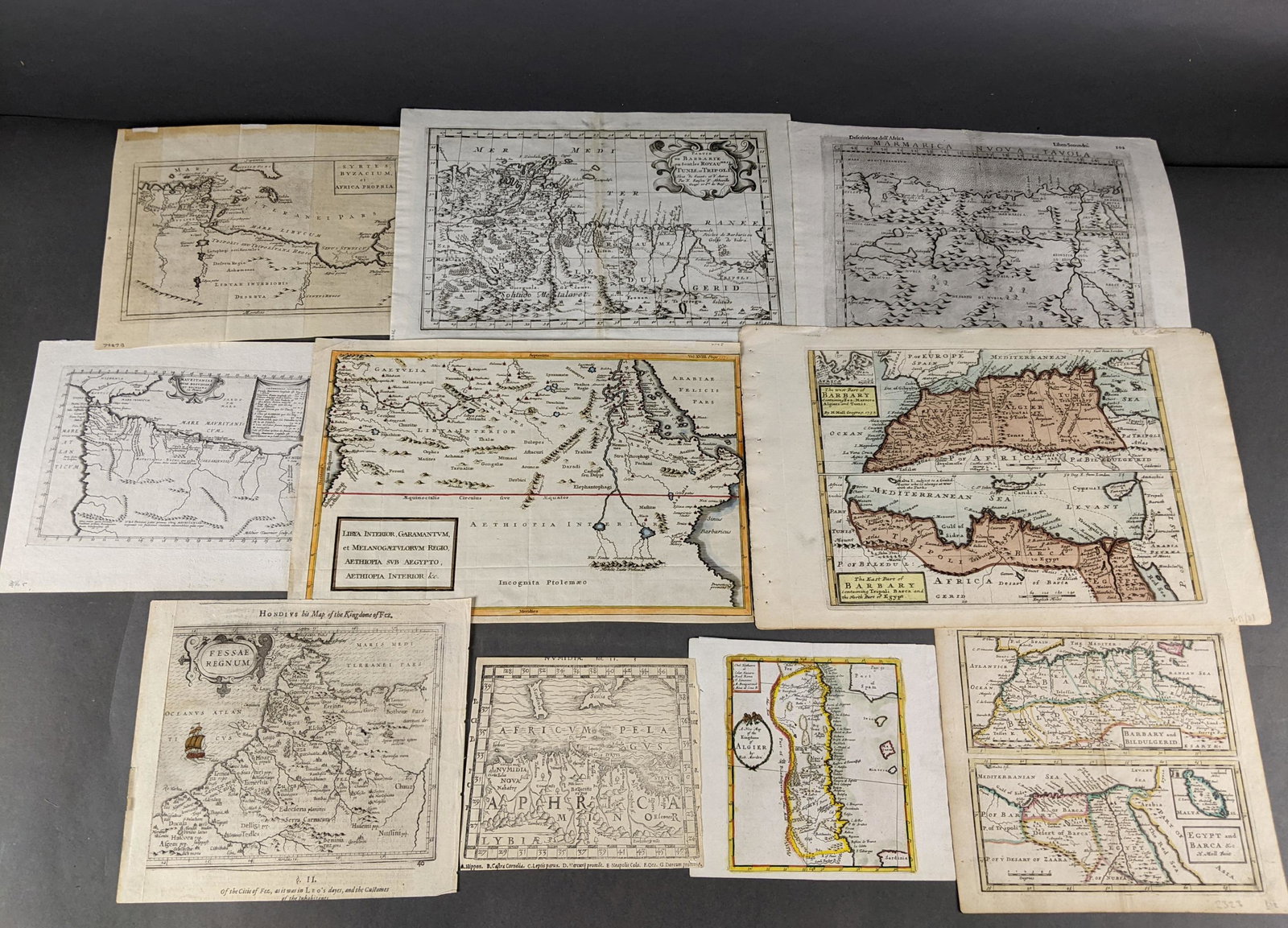 10 Maps of North Africa.: [Maps/Atlases] 10 copperplate engraved maps of North Africa. Dates ranging from the late 1500s to mid 1700s. 4 hand colored. Some after Munster and Hondius.Condition: Minor spotting to maps.