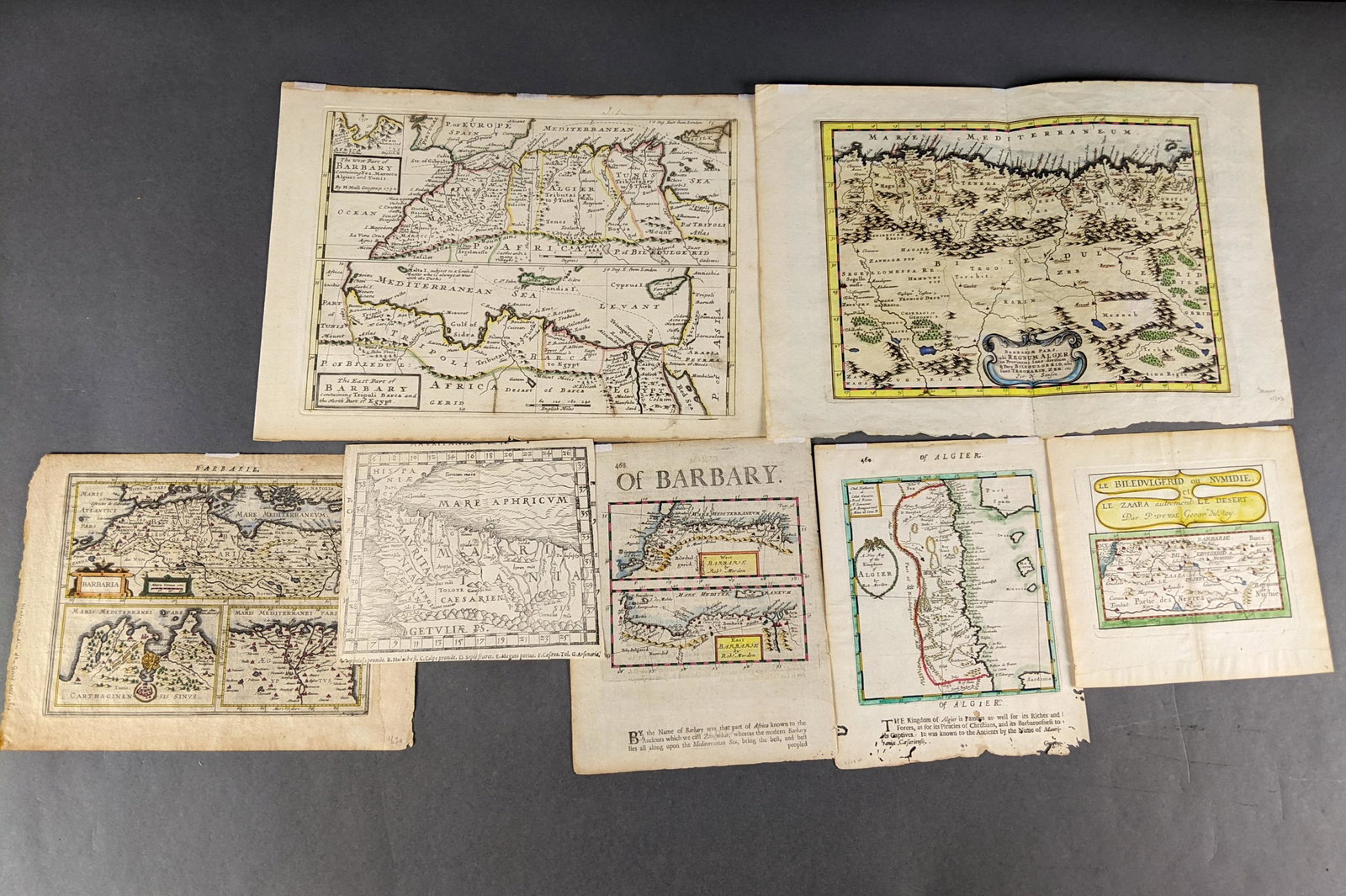 7 Maps of North Africa.: [Maps/Atlases] 7 copperplate engraved maps of North Africa. Dates ranging from the late 1500s to mid 1700s. 6 hand colored. Some after Munster, Moll and Hondius.Condition: Minor spotting to maps.