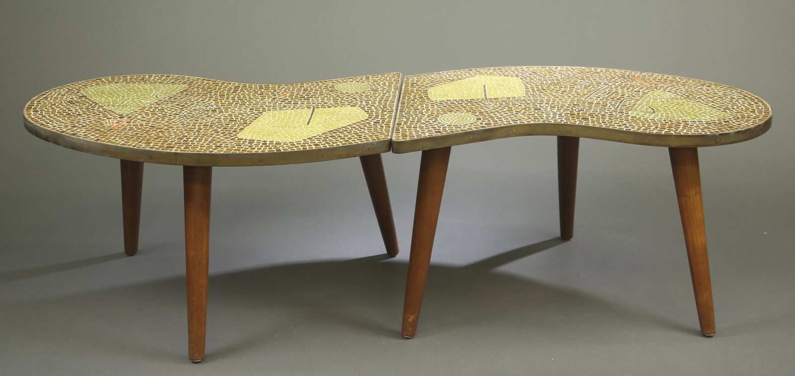 Modern mosaic tables.: A set of amorphous wood coffee table with green, brown, orange, and black mosaic tiles in a geometric design. Two tables can be placed together to form a coffee table. 16 3/4" x 58 3/4". Tables were p