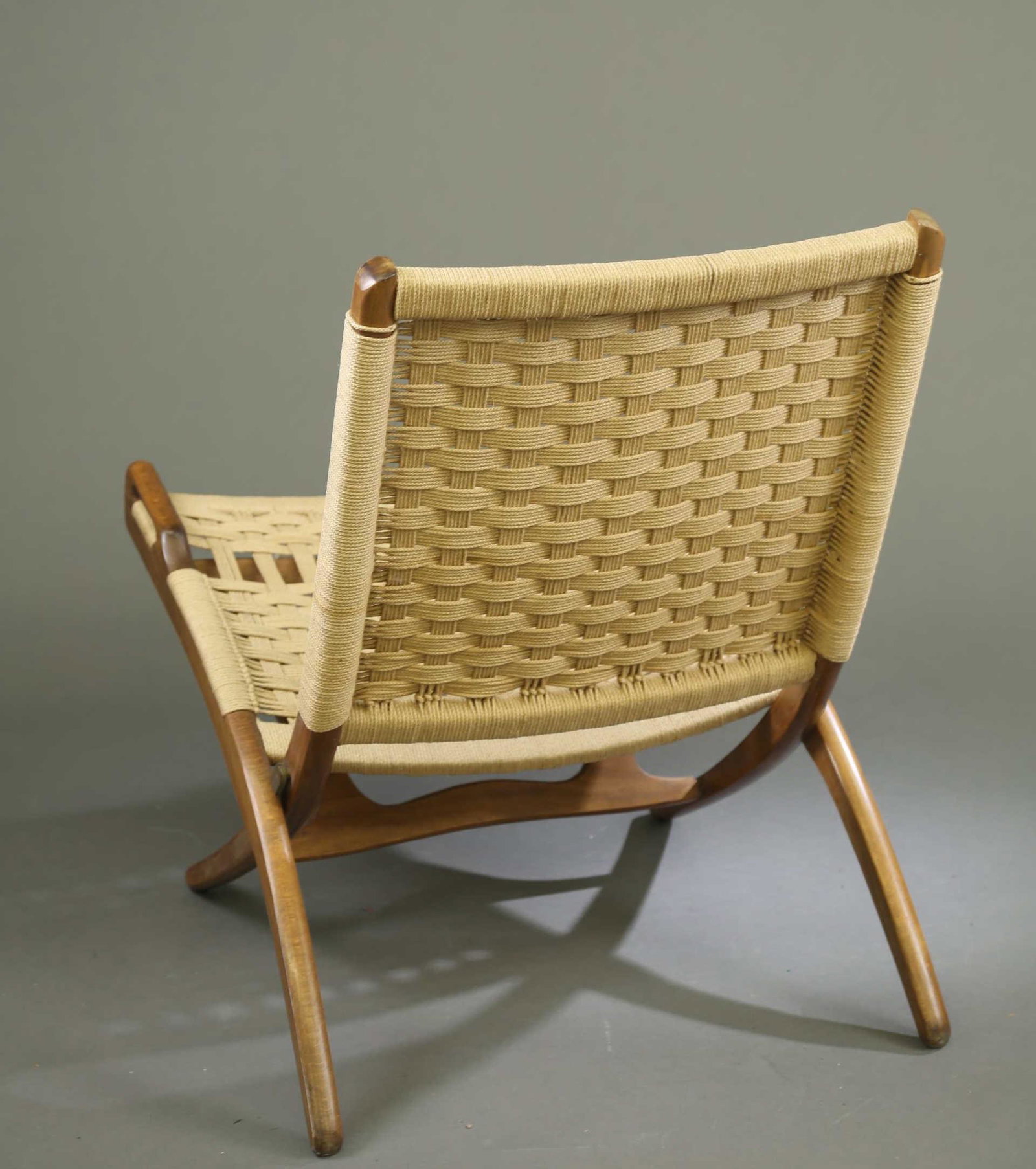 H. Wegner style folding chair.: A Hans J. Wegner (Danish, 1914-2007) style rope folding chair. Danish rope seat and back. Marked "MADE IN YUGOSLAVIA." 34" x 23 1/4" x 32".