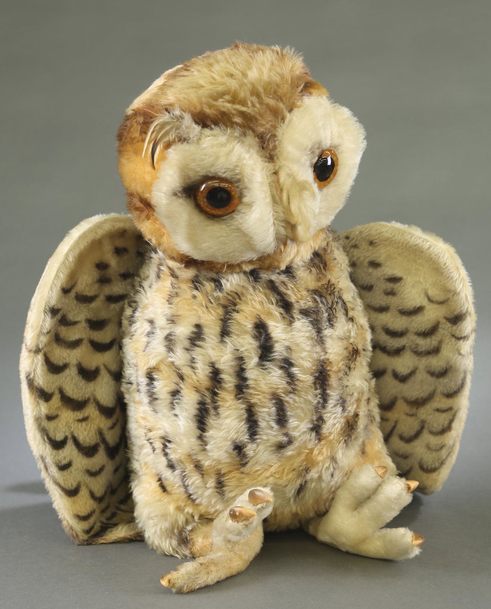 Large Steiff stuffed owl.: A large Steiff stuffed owl. Original Steiff button and tag. 22 1/2" tall.Condition: Missing beak. Staining.