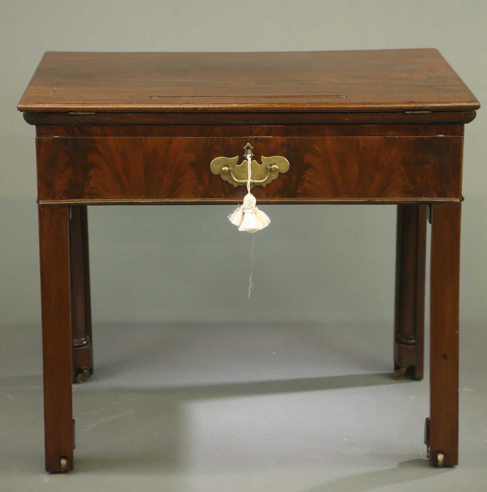 Victorian drafting table.: A Victorian mahogany drafting table. Late 19th century. Front pulls out to reveal leather lined writing surface that retracts for under storage. Hinged top releases with push button and ratchet adjust