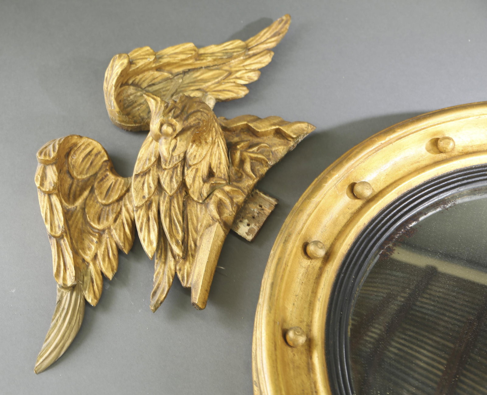American Federal mirror.: An American Federal convex mirror. Surmounted by a carved wooden eagle. Early 19th century. 36" x 25 1/2".