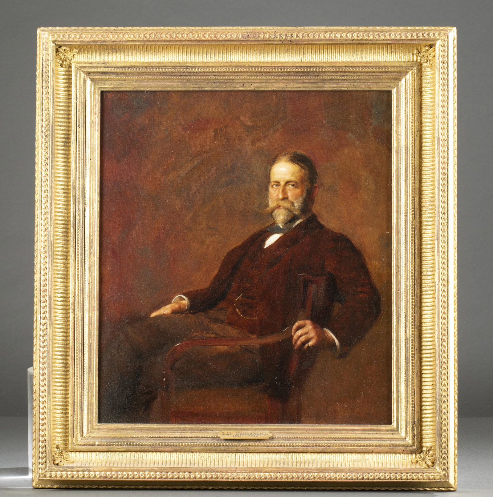 I.M. Gaugengigl, Portrait, O/C.: Gaugengigl, Ignaz Marcel (German/American,1855-1932). Portrait of a gentleman, subject sitting in an armchair and wearing a maroon coat. Oil on canvas. Signed U/L "I.M. Gaugengigl 1903." Sight: 15 1/4