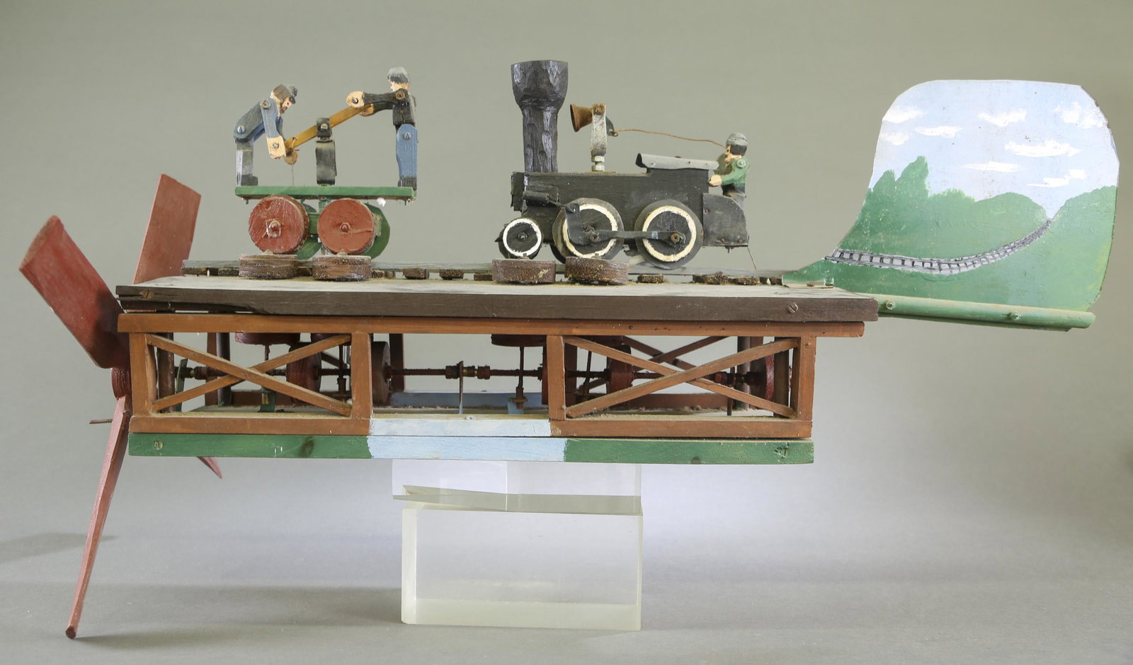 Folk Art railroad whirligig.: A Folk Art railroad whirligig. Painted wood. 20th century. 14" x 37" x 18".