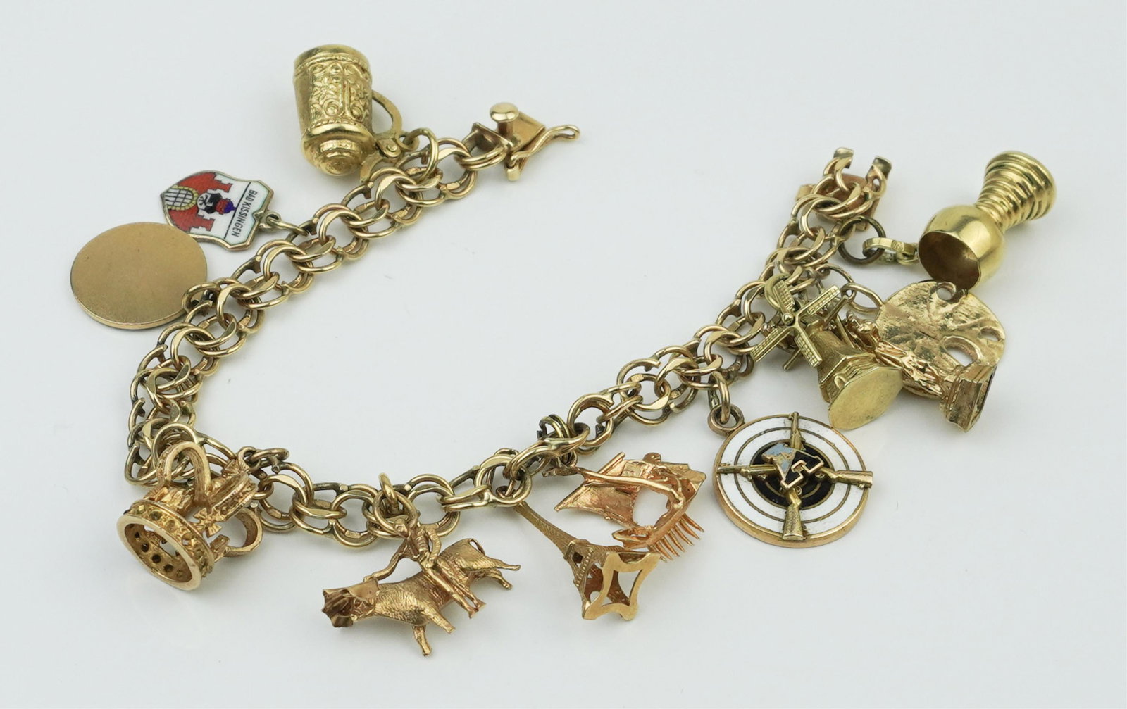 14KYG Charm bracelet with 14K & 10K charms.: A 14KYG charm bracelet with 14K & 10K charms. Bracelet stamped and tested 14K yellow gold. Twelve charms total with eight charms in 14K yellow gold and four charms in 10K yellow gold. Gross weight app