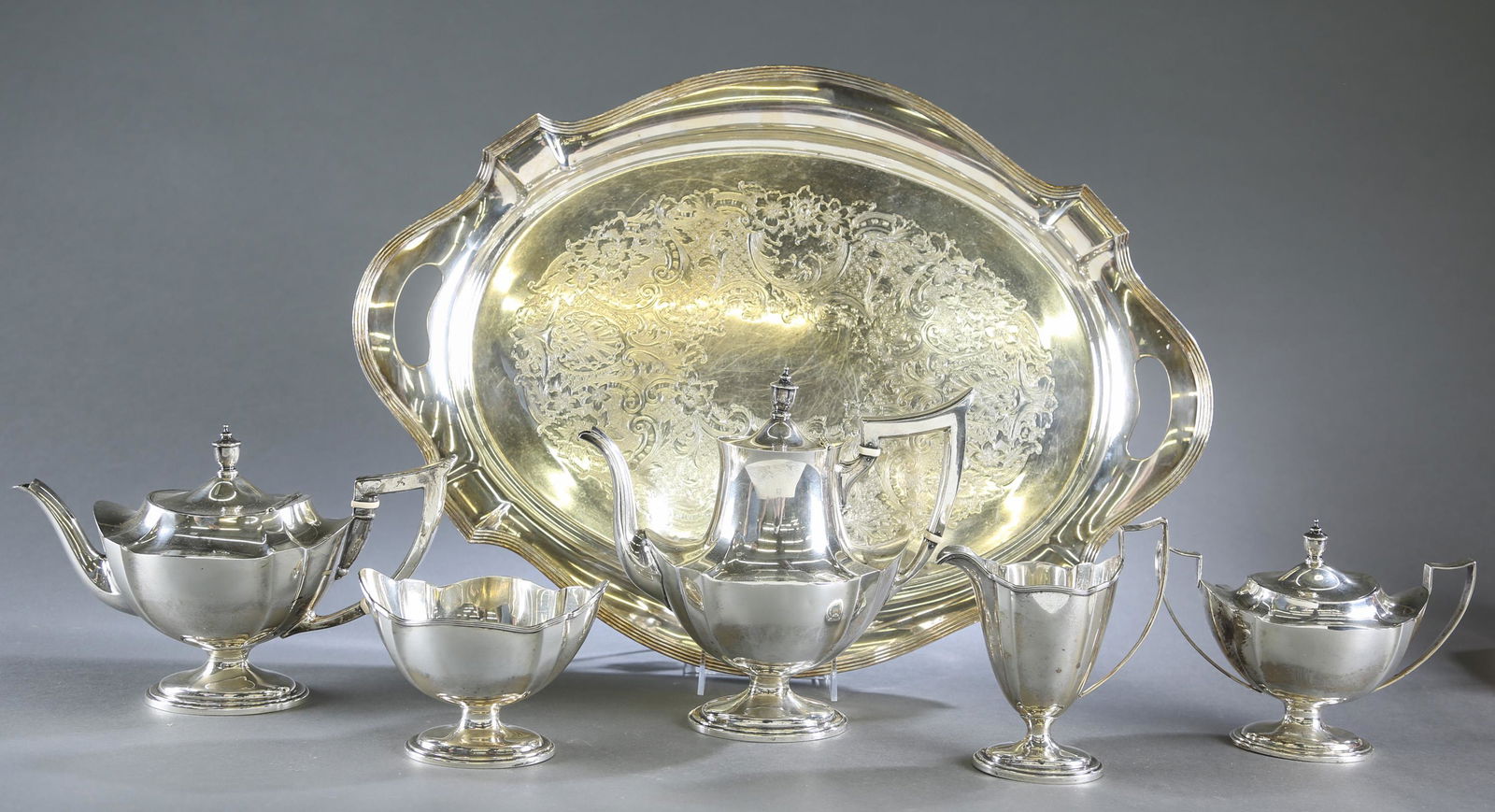 Gorham Plymouth sterling five piece tea service.: A Gorham "Plymouth" pattern sterling silver five piece tea service and Gorham silverplate tea tray. Circa 1952. Coffee pot 9 3/4" x 10 1/4" x 5" 24.09 ozt. Tea pot. 7" x 12" x 5 1/4" 21.07 ozt. Creame