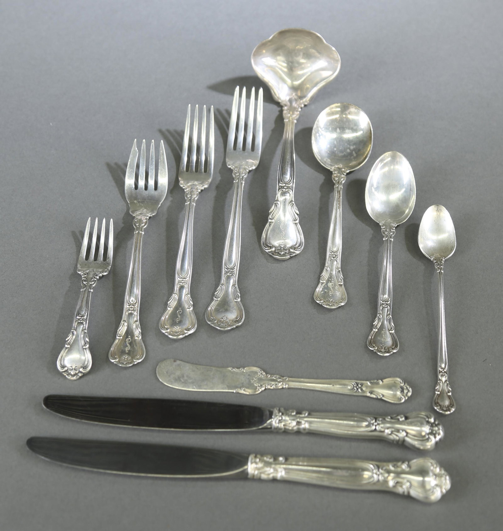 Gorham "Chantilly" sterling flatware service.: A Gorham "Chantilly" pattern sterling silver flatware service. Seventy-two pieces. 67.4 ozt. Monogrammed. Includes twelve 9" and 8 7/8" hollow place knives, eleven 5 7/8" flat butter knives, six 6 1/4