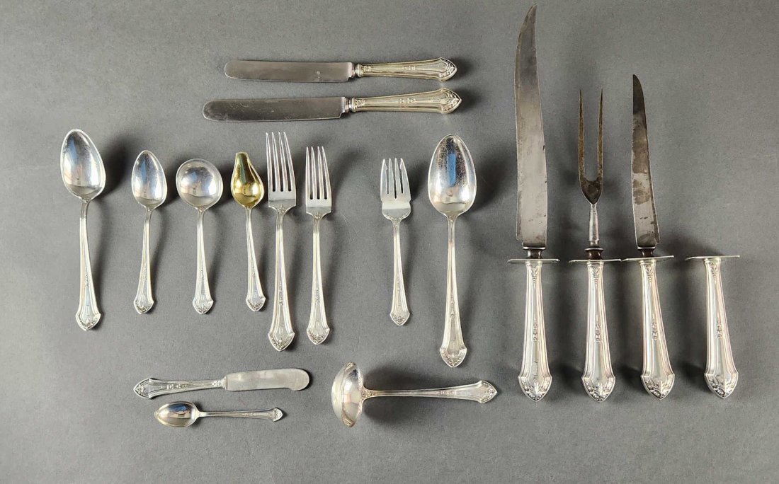 Durgin "Lenox" sterling flatware service.: A Durgin "Lenox" pattern sterling silver flatware service. Monogrammed with letter "D" with Grogan Company mark on reverse. 107 pieces. 103.65 ozt. Includes twelve 7 5/8" dinner forks, twelve 7 1/4" f