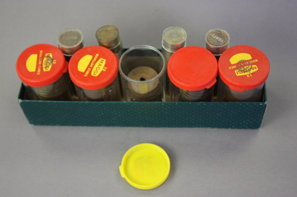 Stacks of coins in tubes including: East Africa, Peru, Cuba, Columbia etc. 20th century.
