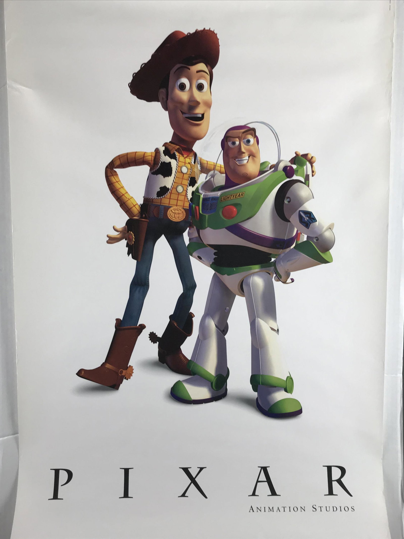 2 Pixar Animation Posters. 1995.: Pixar Behind the Scenes at Pixar poster. Transparent. Ten Years of Creativity. Includes interviews with Steve Jobs and John Lasseter. 27" x 39". ++ Woody and Buzz Pixar Animation Studios Poster. 27" x