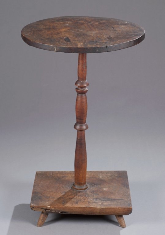 19thC American Candlestand.: American primitive candlestand on peg feet. Second half 19th century. 29"h x 18"diam. Provenance: From the estate of a Virginia family. Condition: Significant damage on shaft. Possible repair.