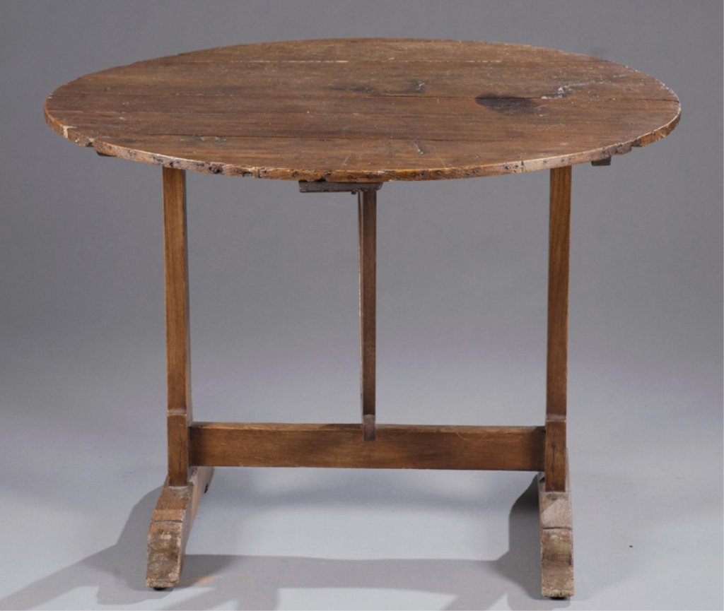19th C. French? Trestle base tilt top wine table.: French wine table. 19th century. On trestle base. 27 1/4"h x 36"diam. Condition: Significant wear throughout.