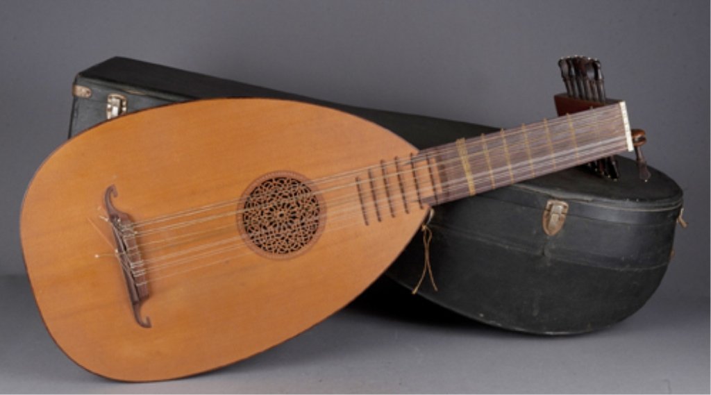 German Lute: German lute with inlaid woods. Additional German and American nylon and steel string packages in velvet lined case. 30 1/2"l. Condition: Good condition.