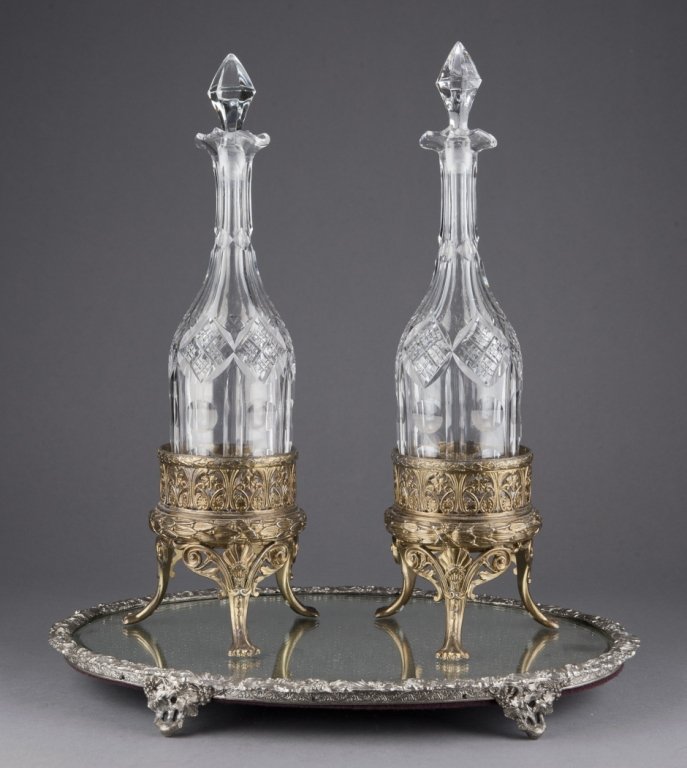 Pair of Pairpoint decanters on mirrored tray.: Group of two cut glass pairpoint decanters on mirrored tray. Late 19th/early 20th century. Decanter: 15 1/2"h x 4 1/2" diam. Tray: 1 1/2"h x 15 3/4"w x 11 1/3"diam. Condition: Some light surface scrat