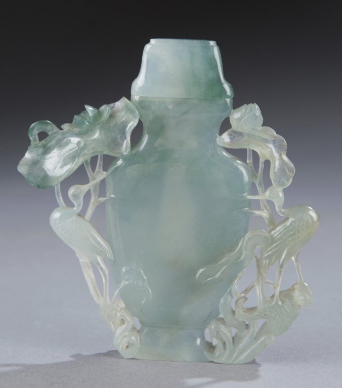 Chinese jade perfume bottle with cranes and lotus.: Chinese jade lidded perfume bottle. 20th century. Carved with cranes and lotuses. 4 3/4"h x 4 1/4"w. Condition: Good.