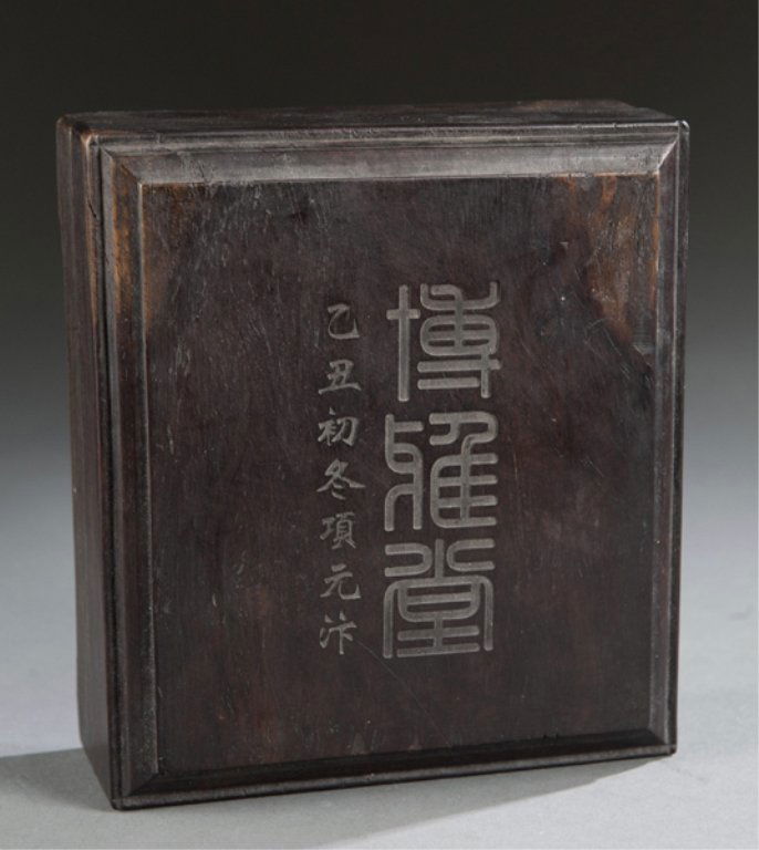 Chinese ink stone with peacock and carved box.: Chinese ink stone with carved peacock detail and wood box. Late 19th/20th century. Stone: 1 1/4"h x 4 3/4"w x 5 1/8"d. Condition: Some scratches, knicks, and wear to stone to both stone and wood.
