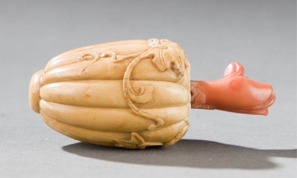 Ivory snuff bottle carved in the form of a melon: Chinese ivory melon carved snuff bottle c. 1870-1900 Form of a lobed melon with vines and leaves, with coral stem form stopper. 1 17/16" l. Provenance: From the Collection of John W. Sinclair, Califor