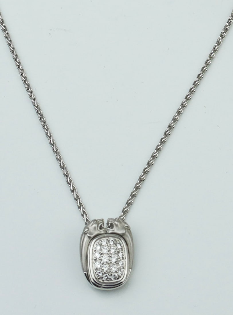 Carrera y Carrera 18KWG and diamond pave pendant: A Carrera y Carrera 18KWG and diamond pave pendant approx. 18" rope style pendant chain with pendant approx. 5/8" x 1/2" depicting two opposing jaguars over pave diamonds approx. .40cttw., stamped CyC