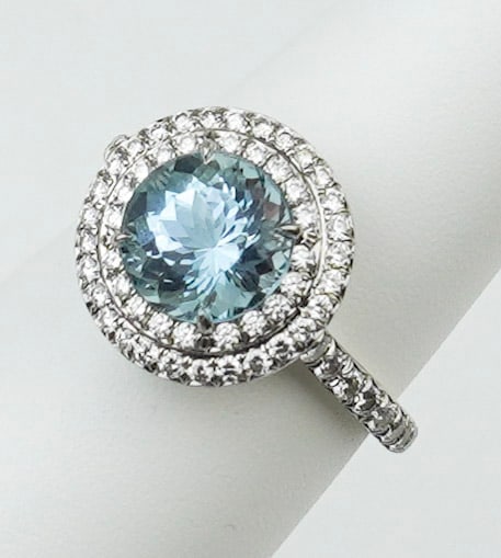 Tiffany & Co. Plat. Diamond & Aqua "SOLESTE" Ring: A Tiffany & Co. platinum, diamond and aquamarine "SOLESTE" ring size 6, platinum mounting with two rows of micro-set diamonds surrounding a round faceted aquamarine approx. 1.86ct, micro-set diamonds 