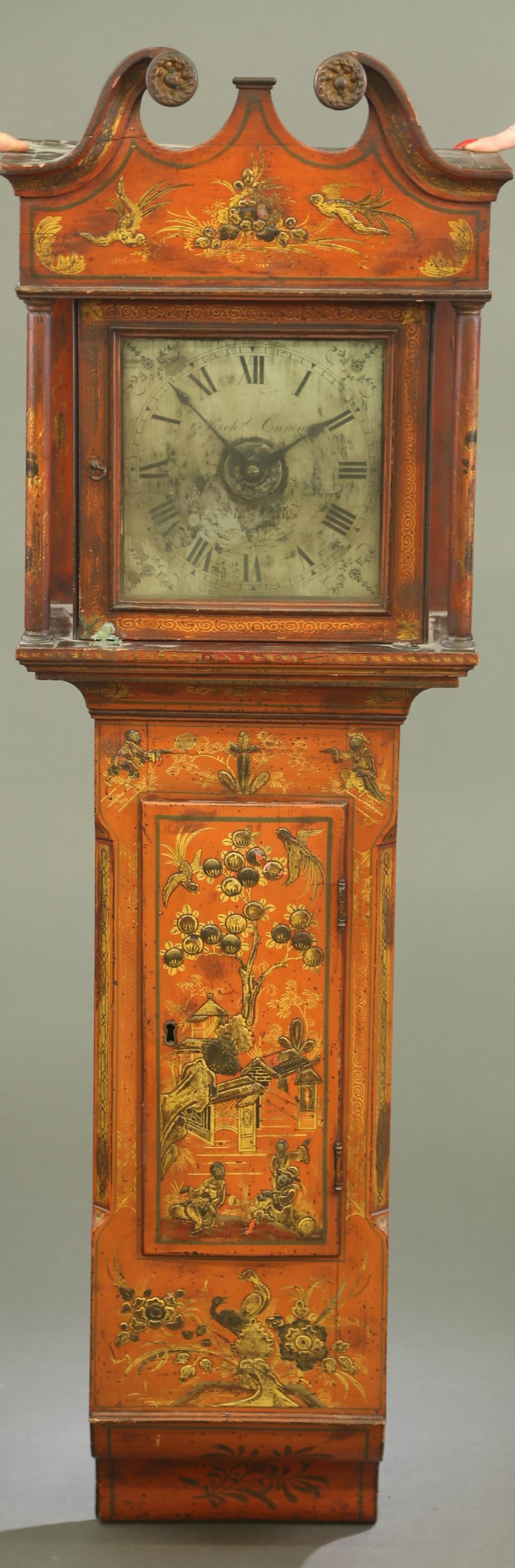English chinoiserie wall clock.: An English chinoiserie wall clock. Early 19th century. Open pediment hood with two columns. Painted wood case with red and gold decoration of Asian pastoral scene. Silvered face with Roman numerals ma