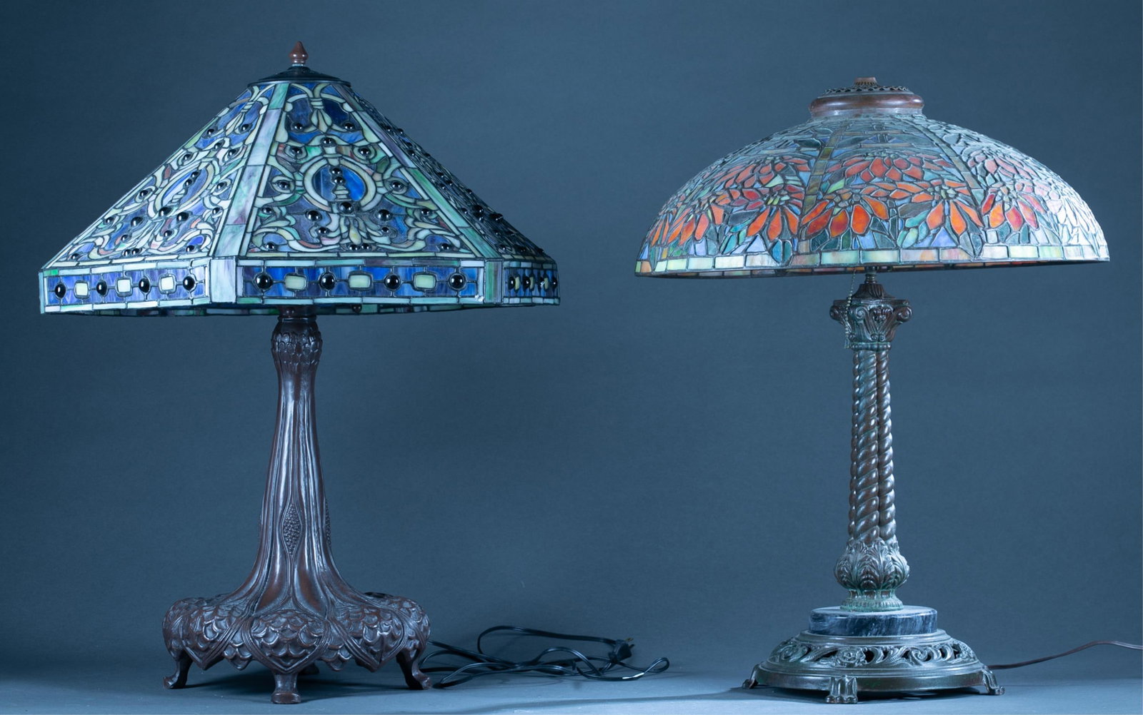 2 Tiffany style lamps: A group of two Tiffany style lamps with shades. ++ Medya Tiffany lamp with floral leaded shade. Lamp: 31 3/4" x 9" and shade: 31 1/4" x 9" ++ Tiffany style lamp. Marked on bottom "TIFFANY STUDIOS/ NEW