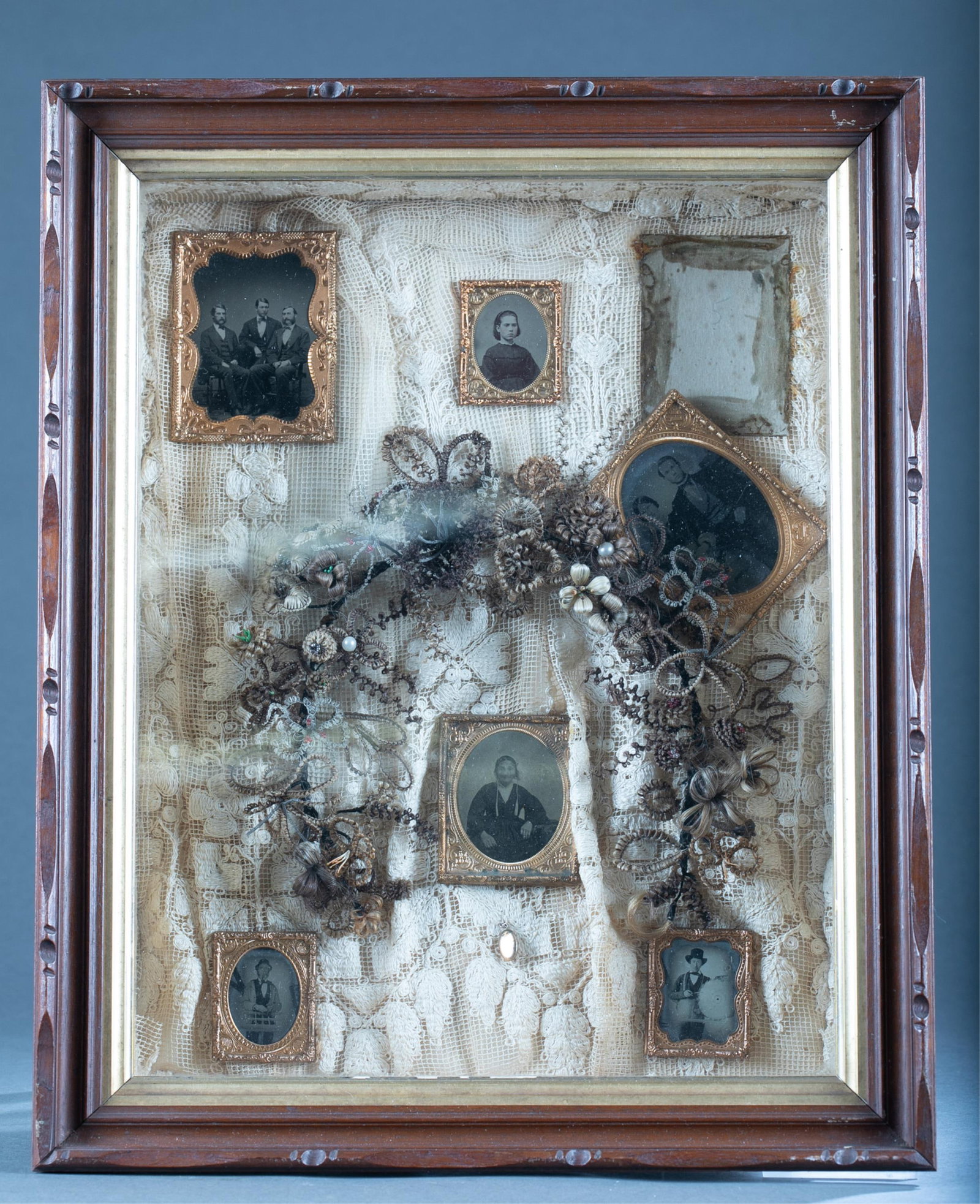Mourning hair wreath.: A shadowbox of a mourning hair wreath and six daguerreotypes. The hair was collected from six generations of the Yuell family. Typed description and additional daguerreotype included. Frame: 21" x 17"