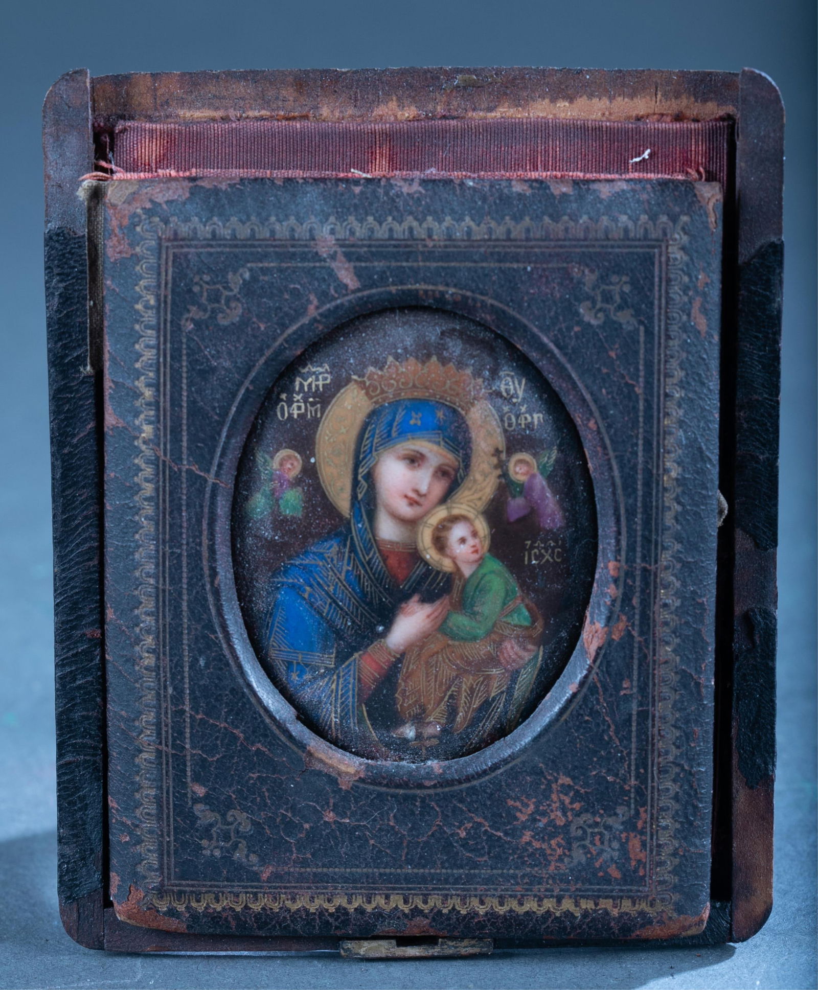 Russian icon of Madonna and child.: A small travel size Russian icon of Madonna and child. Oil on panel. In leather case. 5" x 4".