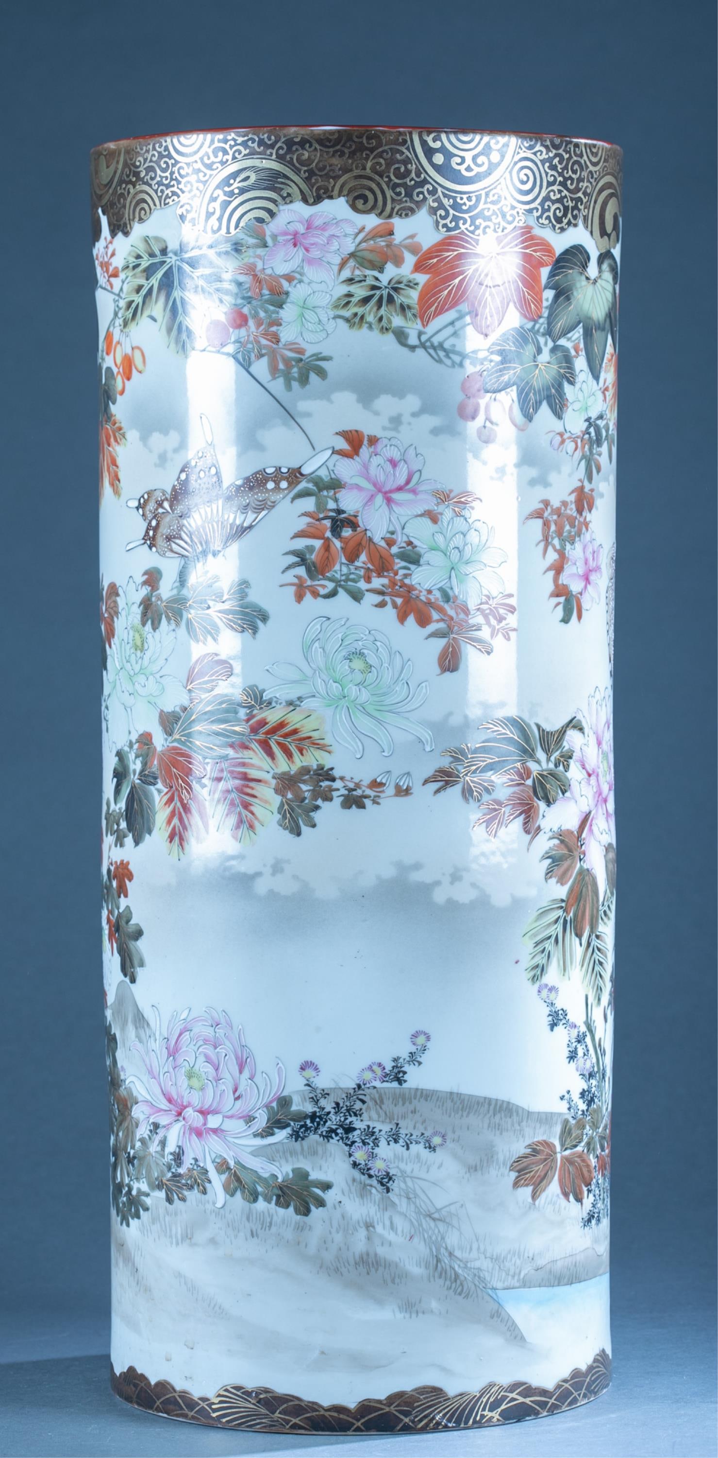 Japanese Satsuma e style Umbrella Stand.: A porcelain umbrella stand in famille rose style. Floral motif including butterflies and peonies. 19th or 20th cent., unmarked. 24"H x 10.25"diam.