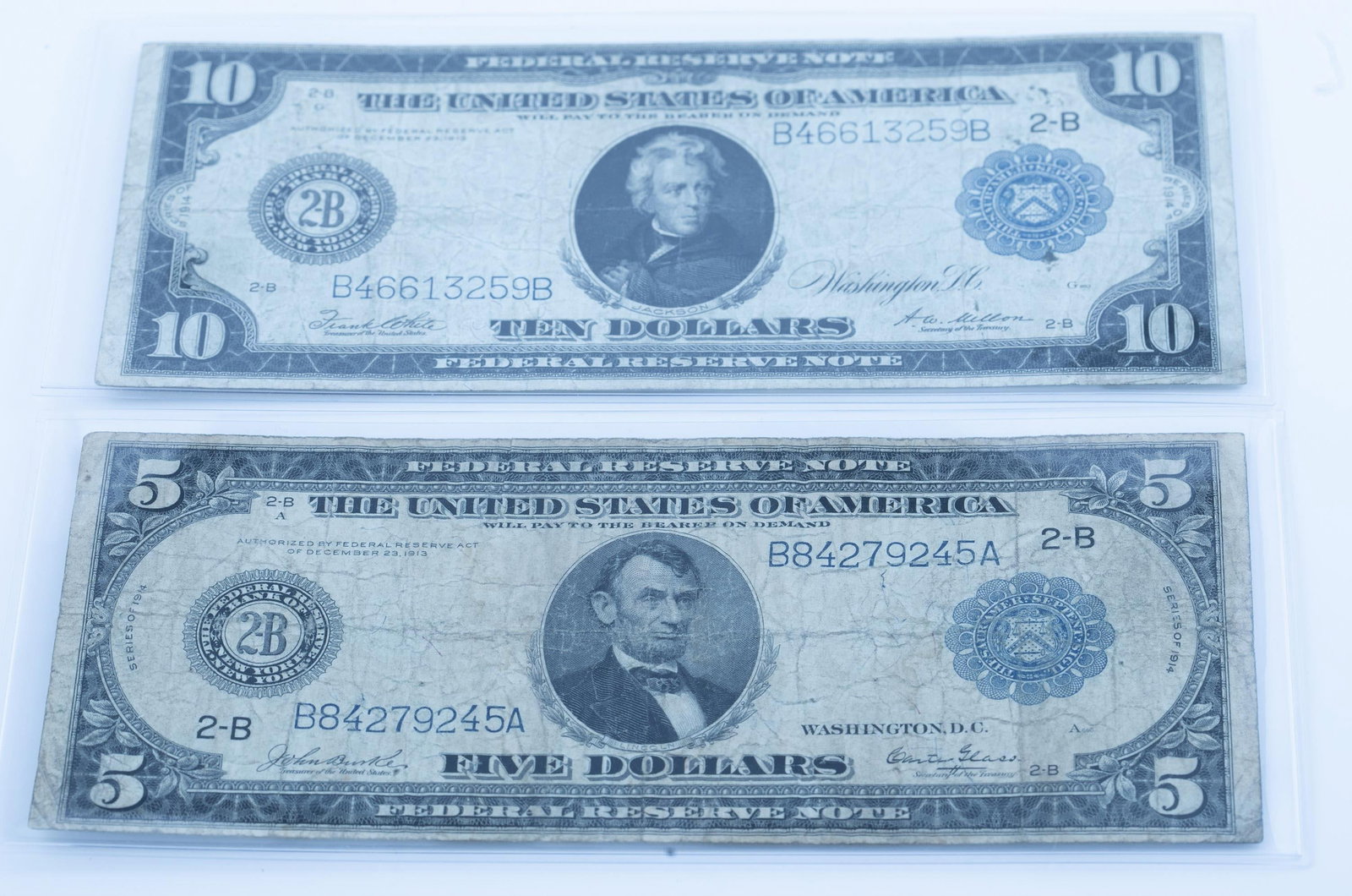 2 U.S.1914 $5 & 10 Large-Size Federal Reserve Note: A group of two U.S. 1914 $5 & 10 Large-Size Federal Reserve Note ++ $5 bank note. John Burke and Carter Glass. Very Good condition ++ $10 bank note. Frank White and Andrew William Mellon. Very Good co