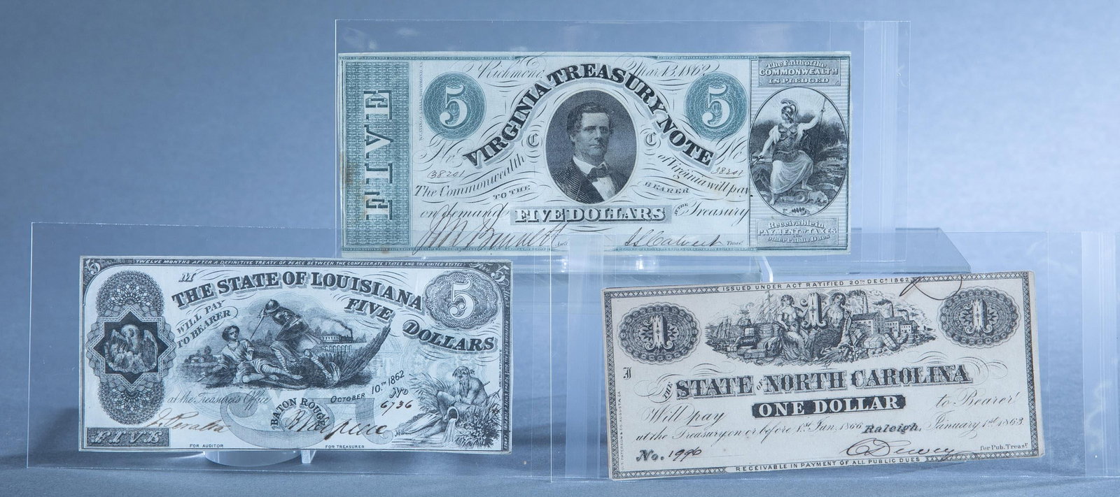 3 Confederate Currency notes: A group of three Confederate Currency notes. Including 1863 The State of North Carolina $1 note Unc, 1862 The State of Louisiana $5 note XF, and 1862 Virginia Treasury Note $5 VF