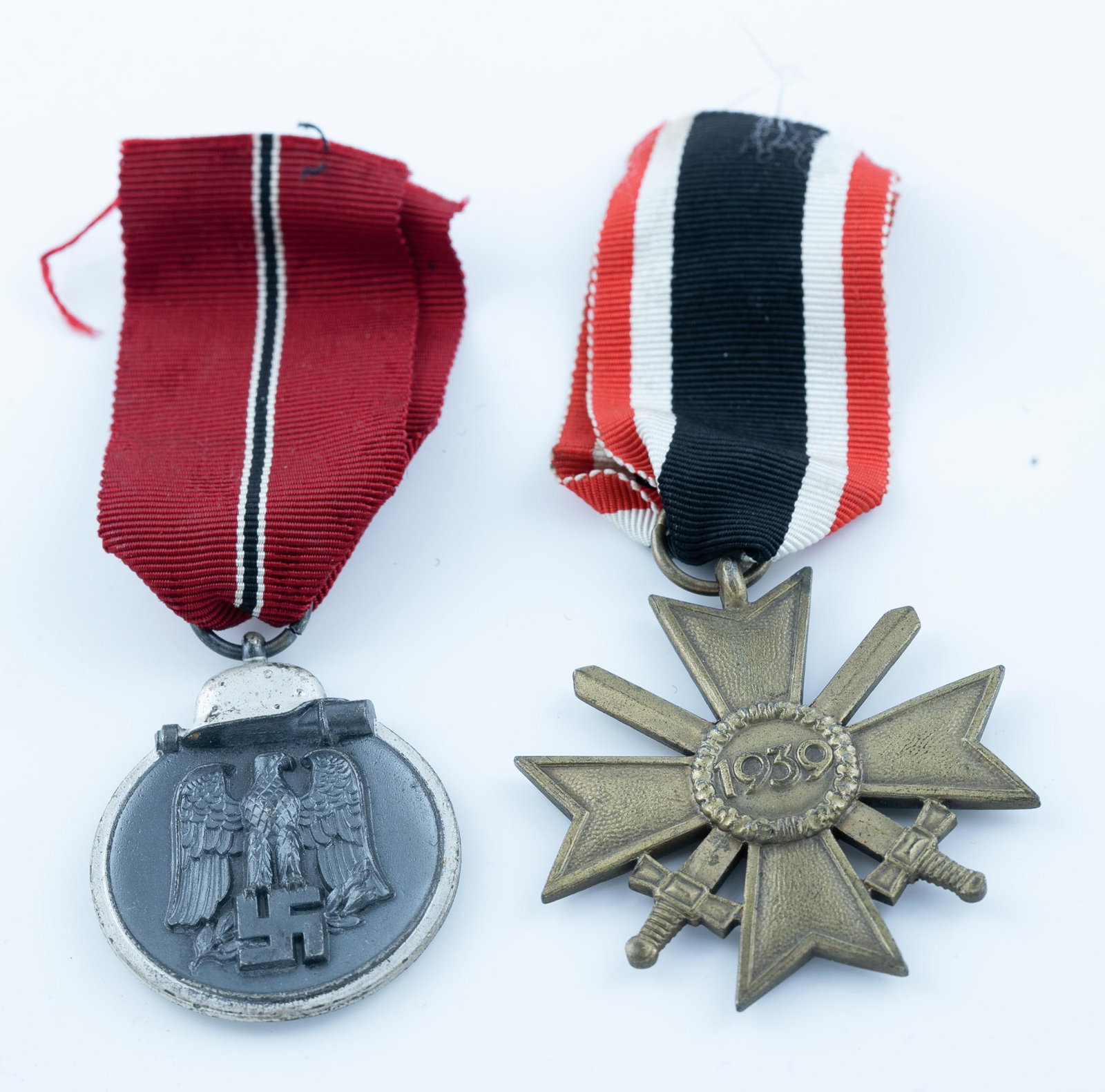 2 WW2 German medals: A group of two WW2 German medals. 1941/42 Winter medal and Bronze War Merit Cross.Condition: War Merit Cross ribbon cut.