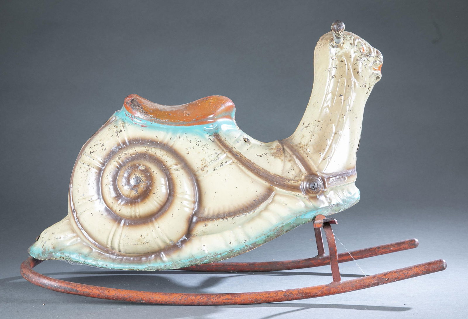 Mobo ride on snail.: A Mobo snail rocking toy. c.1940s-50s. Painted metal. 19" x 28".Provenance: The Pete Cecere Folk Art Collection.