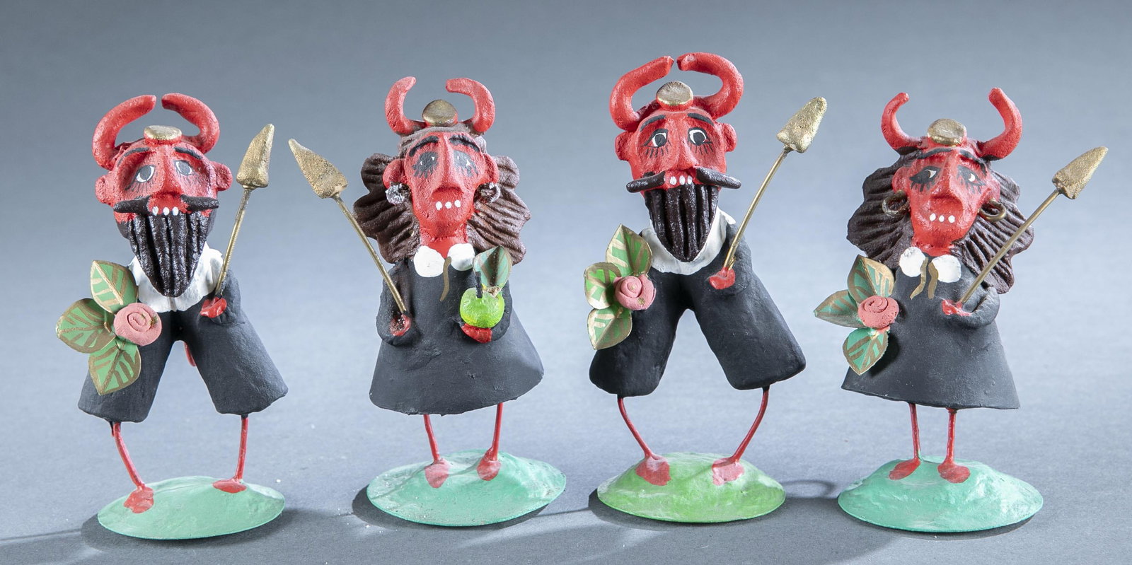 4 Spanish folk art red devils: A group of four Spanish folk art red devils. Painted paper mache and wire. Unsigned. Largest: 5 1/2" x 3 1/4".Provenance: The Pete Cecere Folk Art Collection.