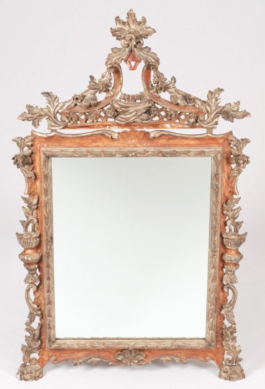 A hand carved square wood mirror w/ foliate crest.: Continental Rococo style carved and stained wood square mirror with foliate crest. Late19th/20th century. Frame with floral and leaf details throughout. Mirror frame: 39" x 32", finial: 16" x 32".