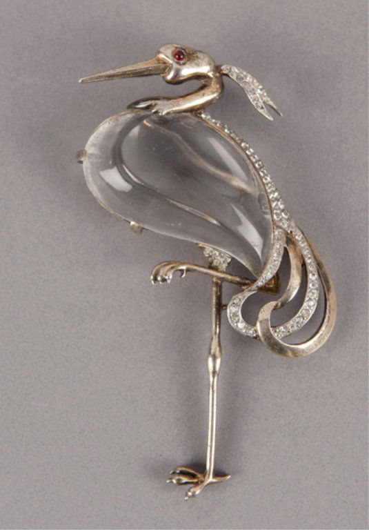 A Trifari stork jelly belly brooch.: Trifari sterling & gold wash brooch. Trifari stork, clear lucite, sterling and gold wash with clear rhinestones and red rhinestone eye. Trifari signature engraved on back. Also sterling and des. pat.