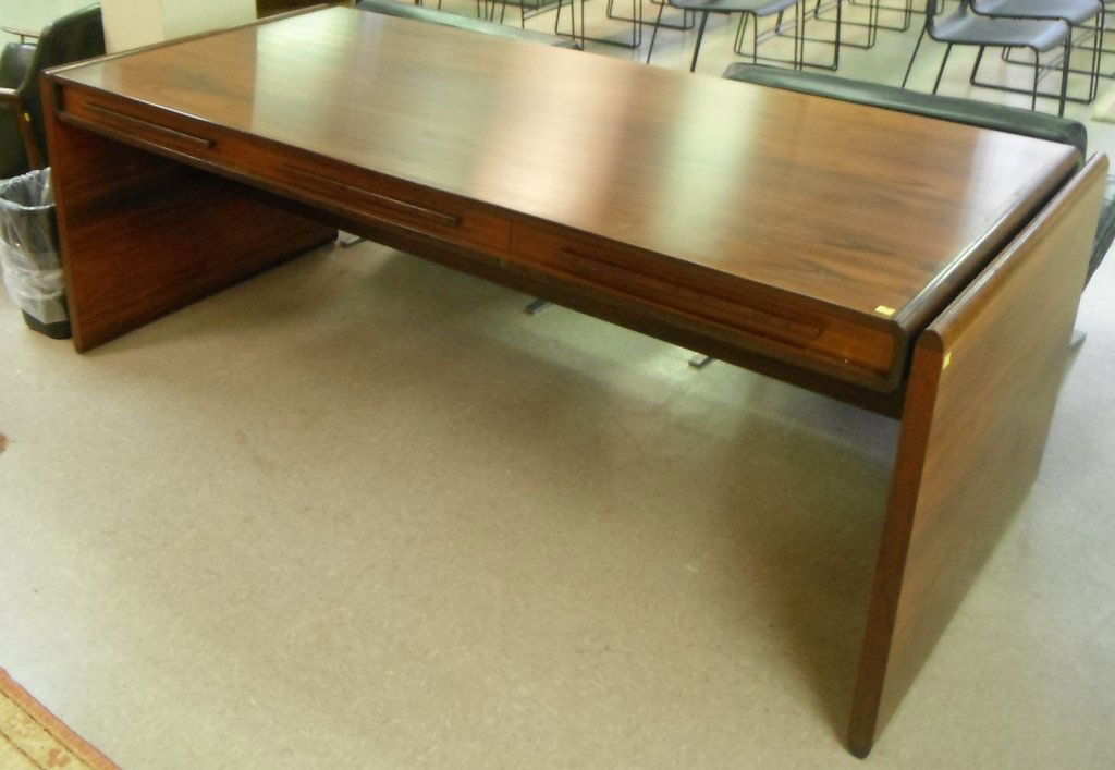 Dyrlund Danish rosewood 3 drawer desk.: Dyrlund Danish rosewood three drawer desk. Mid 20th century. With Dyrlund sticker on bottom. 29"h x 6' 91/2"w x 37 1/2"d.